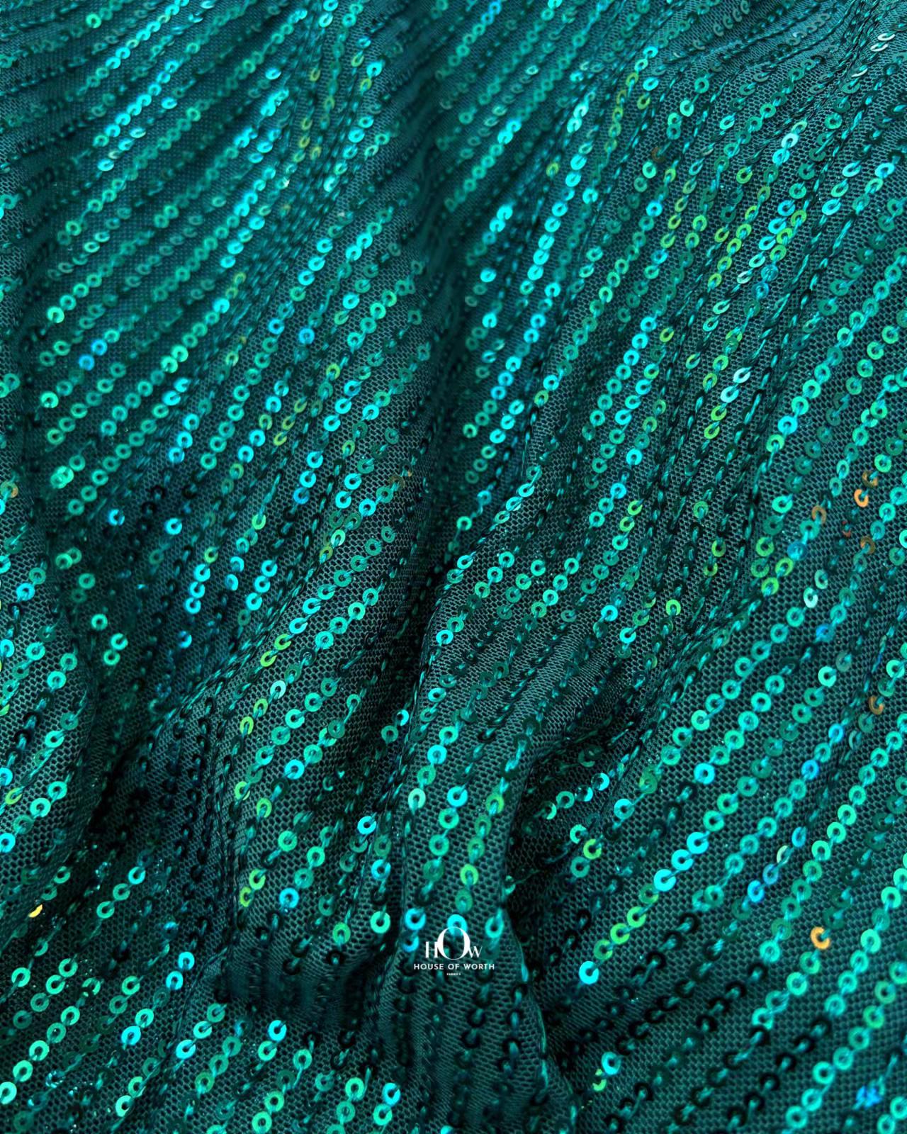 Glossy green China sequins for eveningwear and cocktail dresses – Bhiwandi fabric suppliers.