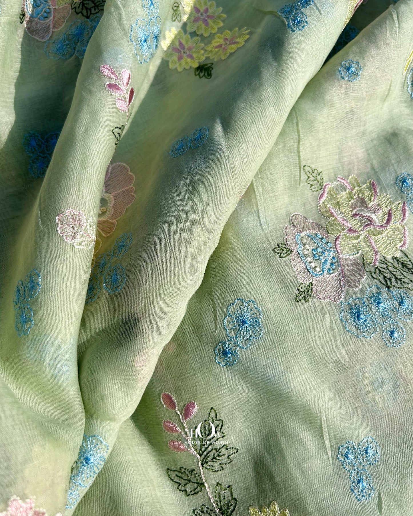 Soft handwoven Mul Chanderi fabric with floral motifs – available in pistachio green for both retail and wholesale orders.