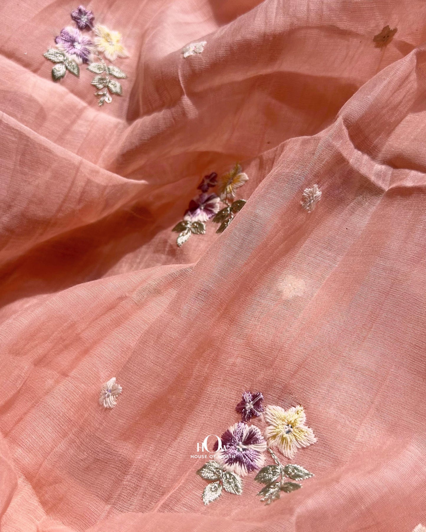 Handwoven Mul Chanderi fabric with colorful thread embroidery – available in peach tone for festive and boutique wear.