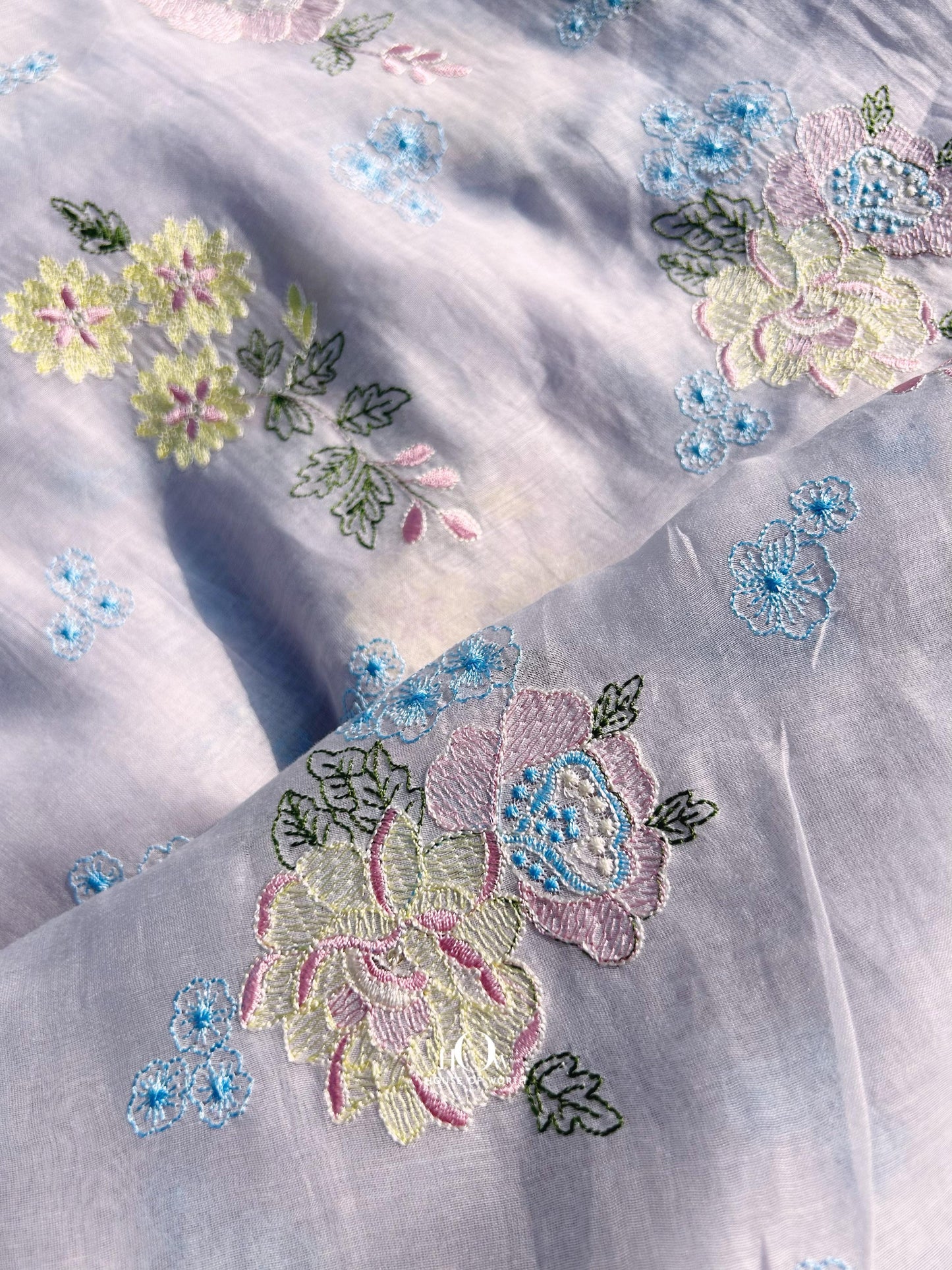 Pure Mul Chanderi fabric in lavender with pastel floral embroidery – perfect for suits, sarees, and occasion wear.