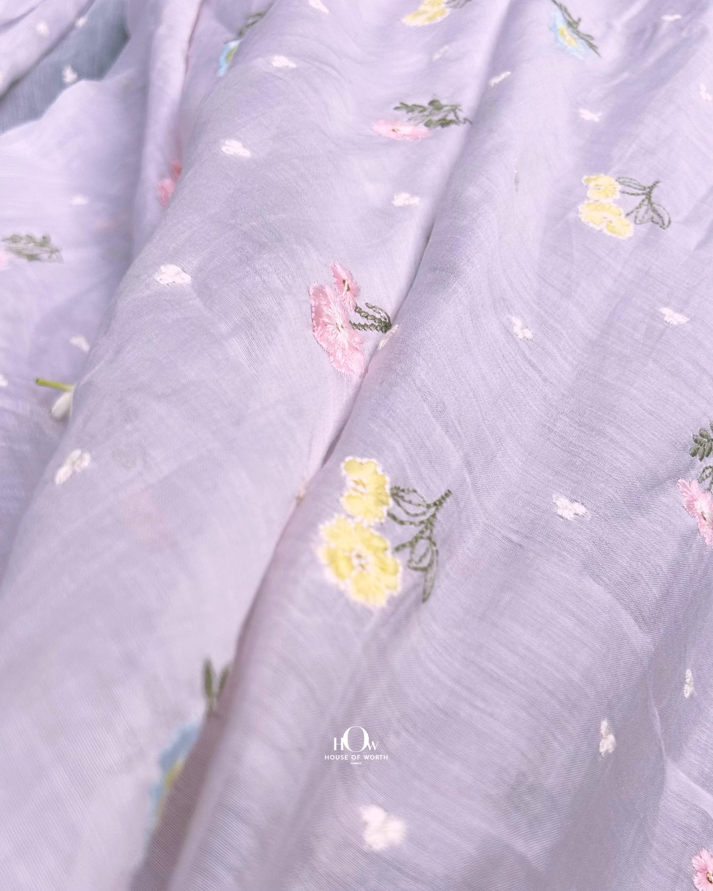 Embroidered Mul Chanderi fabric suppliers in India – premium light blue fabric with soft texture and floral detailing.