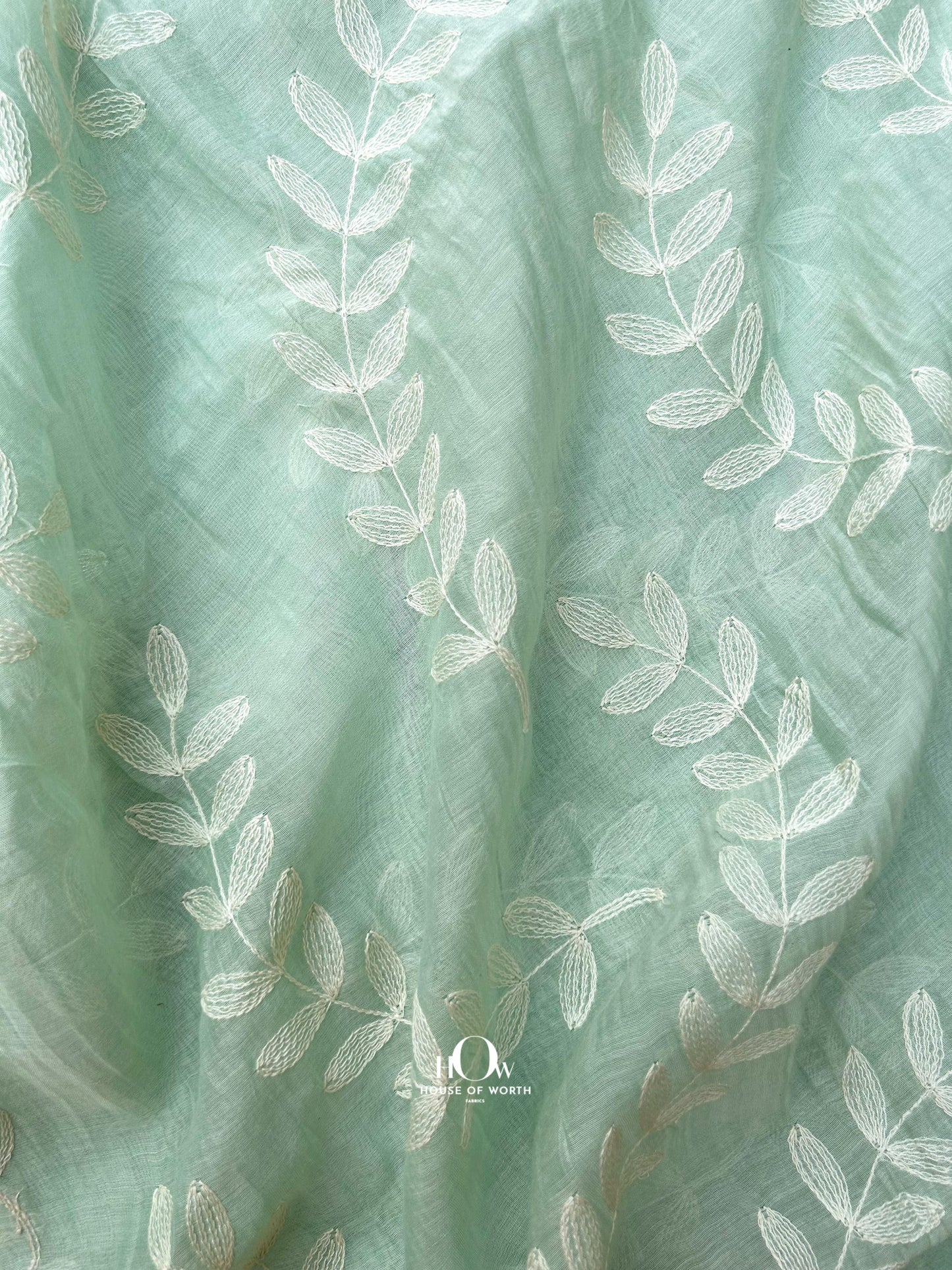 Buy pastel green Pure Mul Chanderi fabric with embroidered leaf pattern – elegant and lightweight for retail and bulk orders.