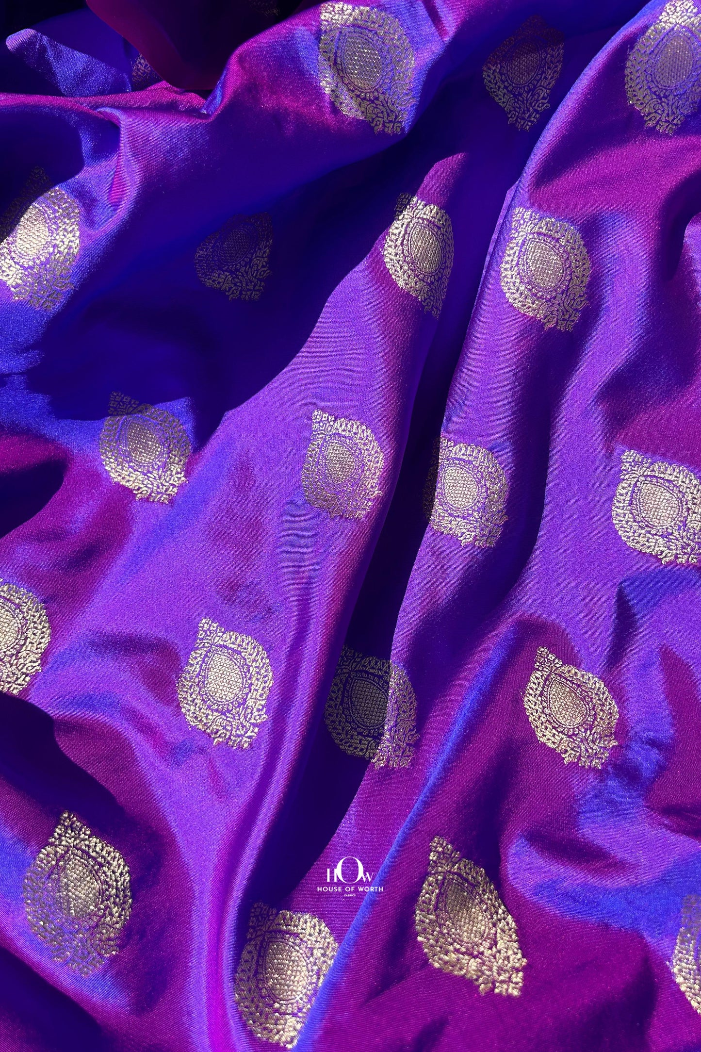 Pure Banarasi silk bridal saree from Varanasi with gold zari work and traditional motifs.