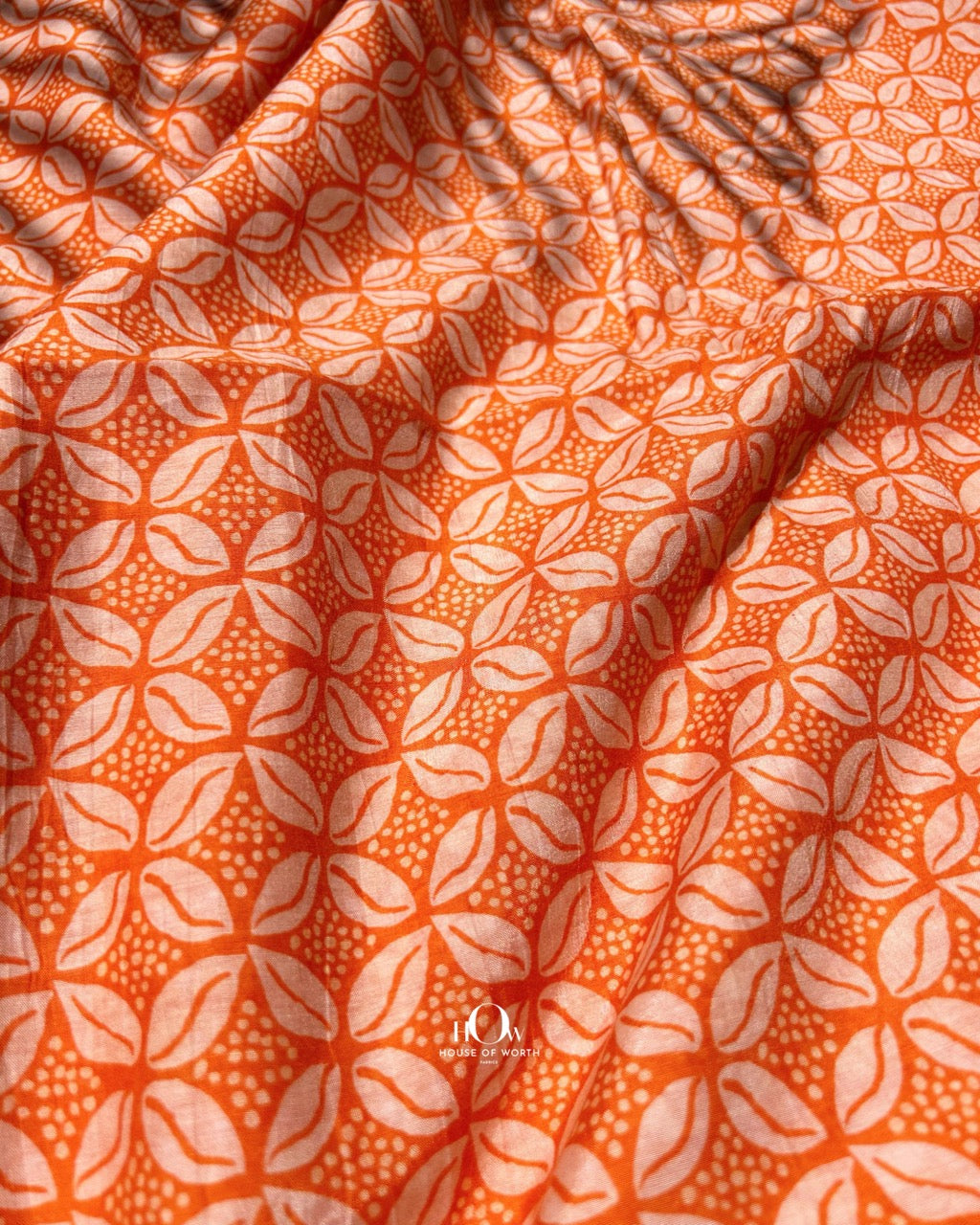 Bold orange Malai Chanderi fabric with all-over print – perfect for kurtis, salwar sets, and festive dresses.
