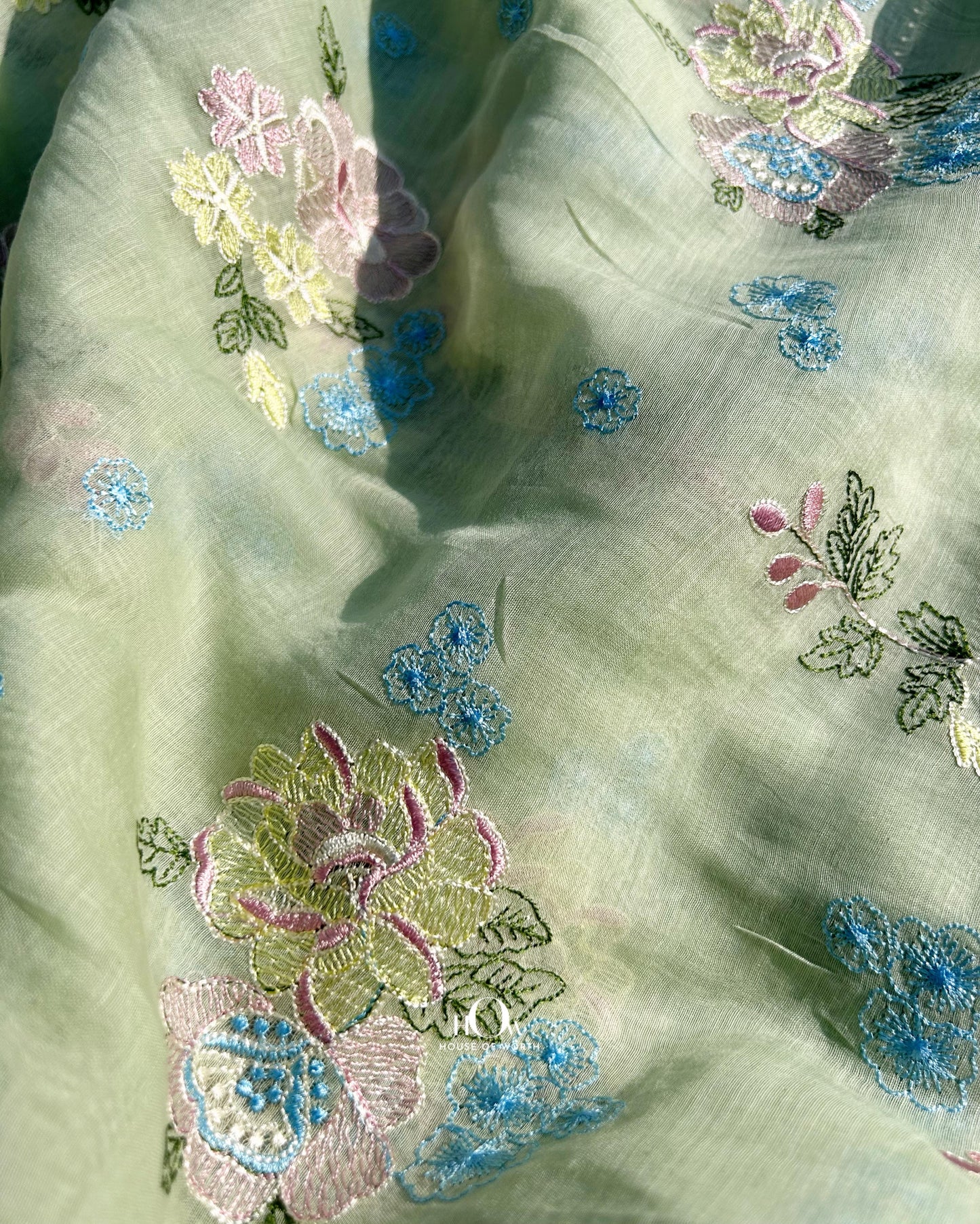 Buy floral embroidered Mul Chanderi fabric in pistachio tone – lightweight and breathable for ethnic wear collections.