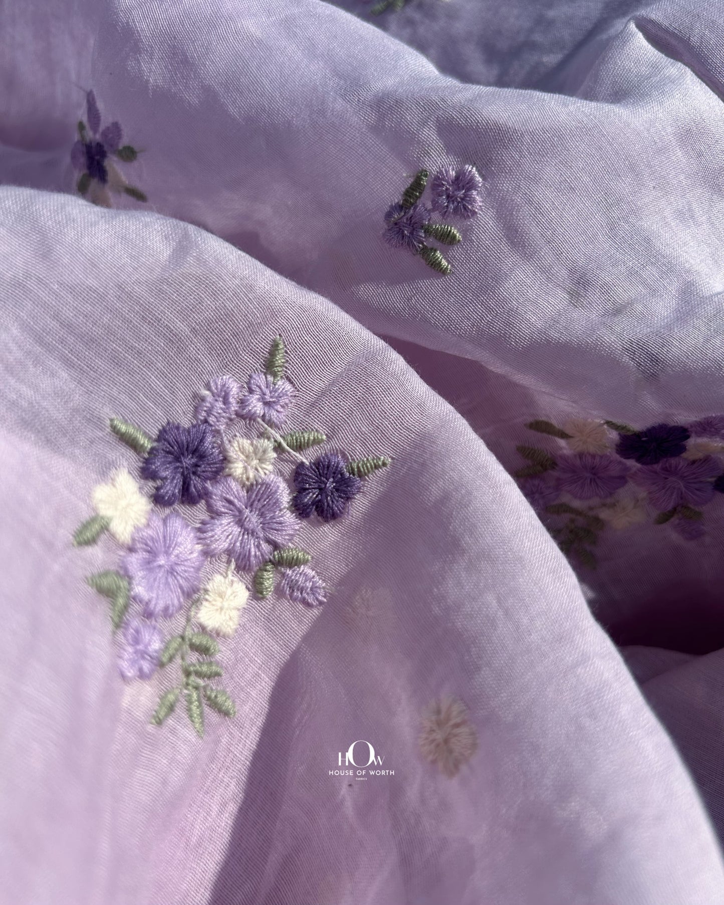 Pastel lavender Chanderi fabric with small floral motifs – perfect for boutique designers and custom tailoring.