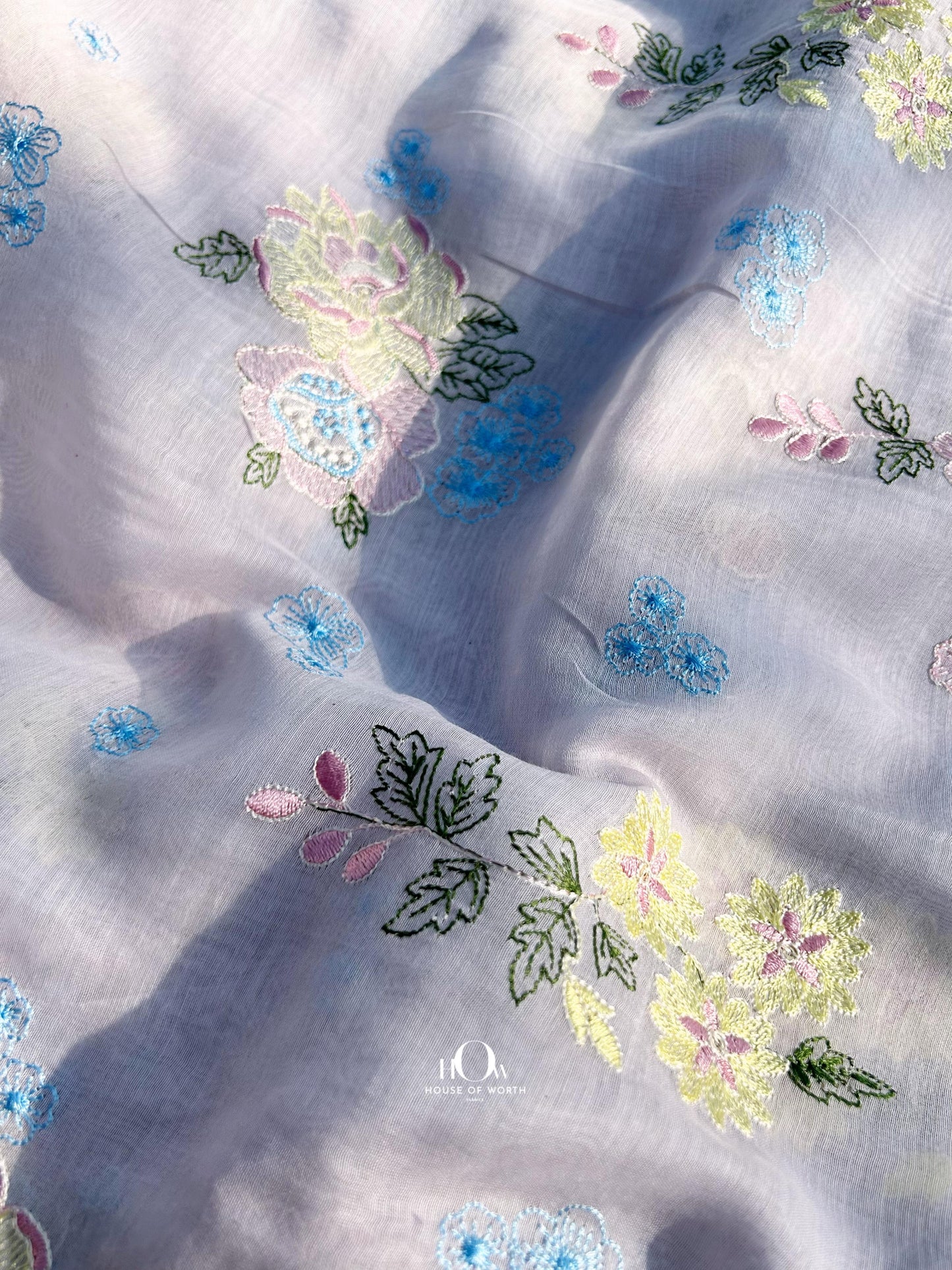 Wholesale supplier of Mul Chanderi fabric in lavender – floral embroidery ideal for custom-made ethnic outfits.