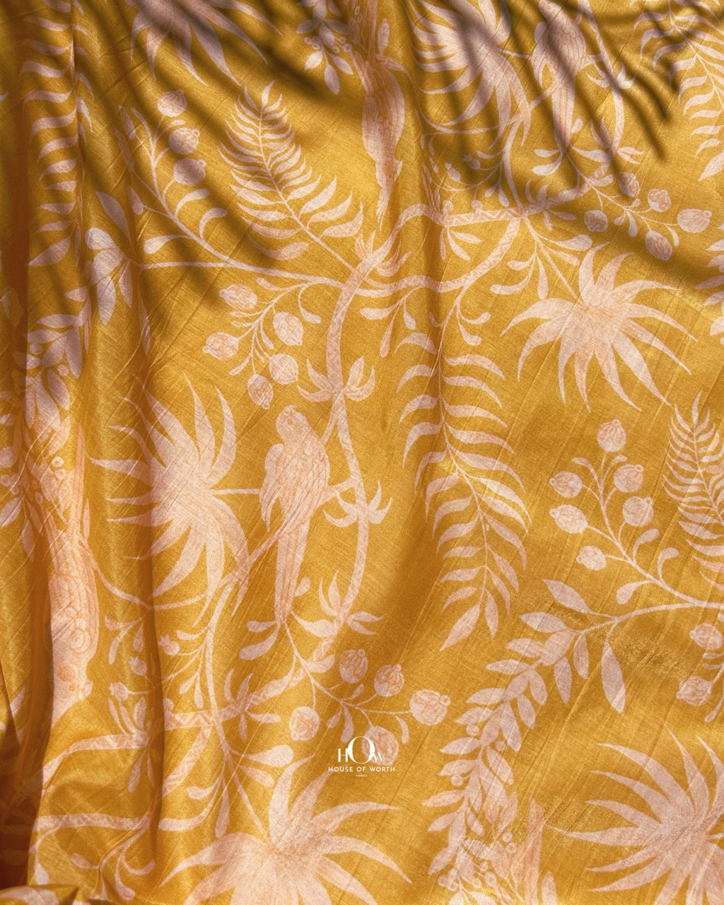 Yellow Mul Chanderi dress material with subtle floral and leaf pattern – perfect for sarees and casual festive looks.