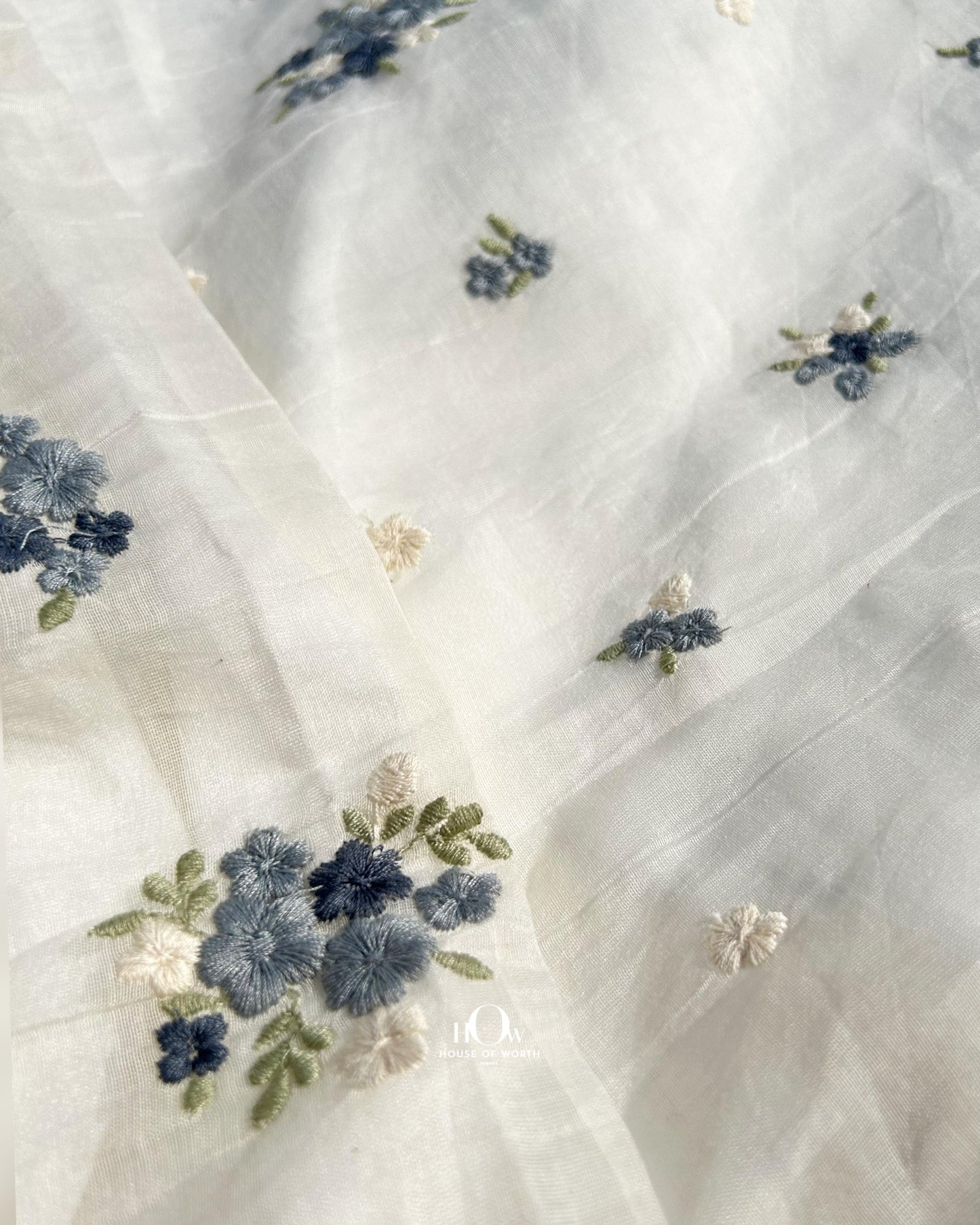 Floral butta dress material in Pure Chanderi – off-white handloom fabric with dual-tone blue embroidery for boutique collections