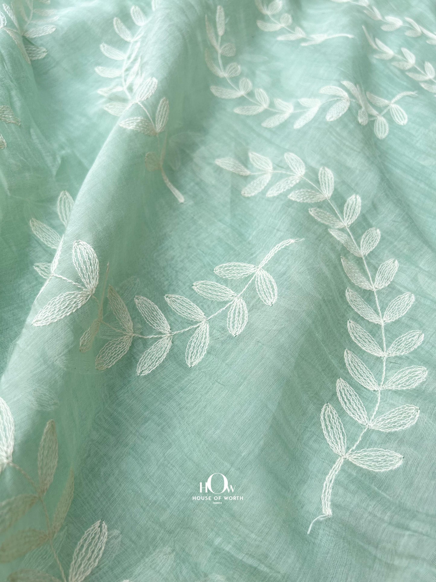 Handwoven Mul Chanderi dress material in mint green – features threadwork leaf motifs, ideal for boutique tailoring