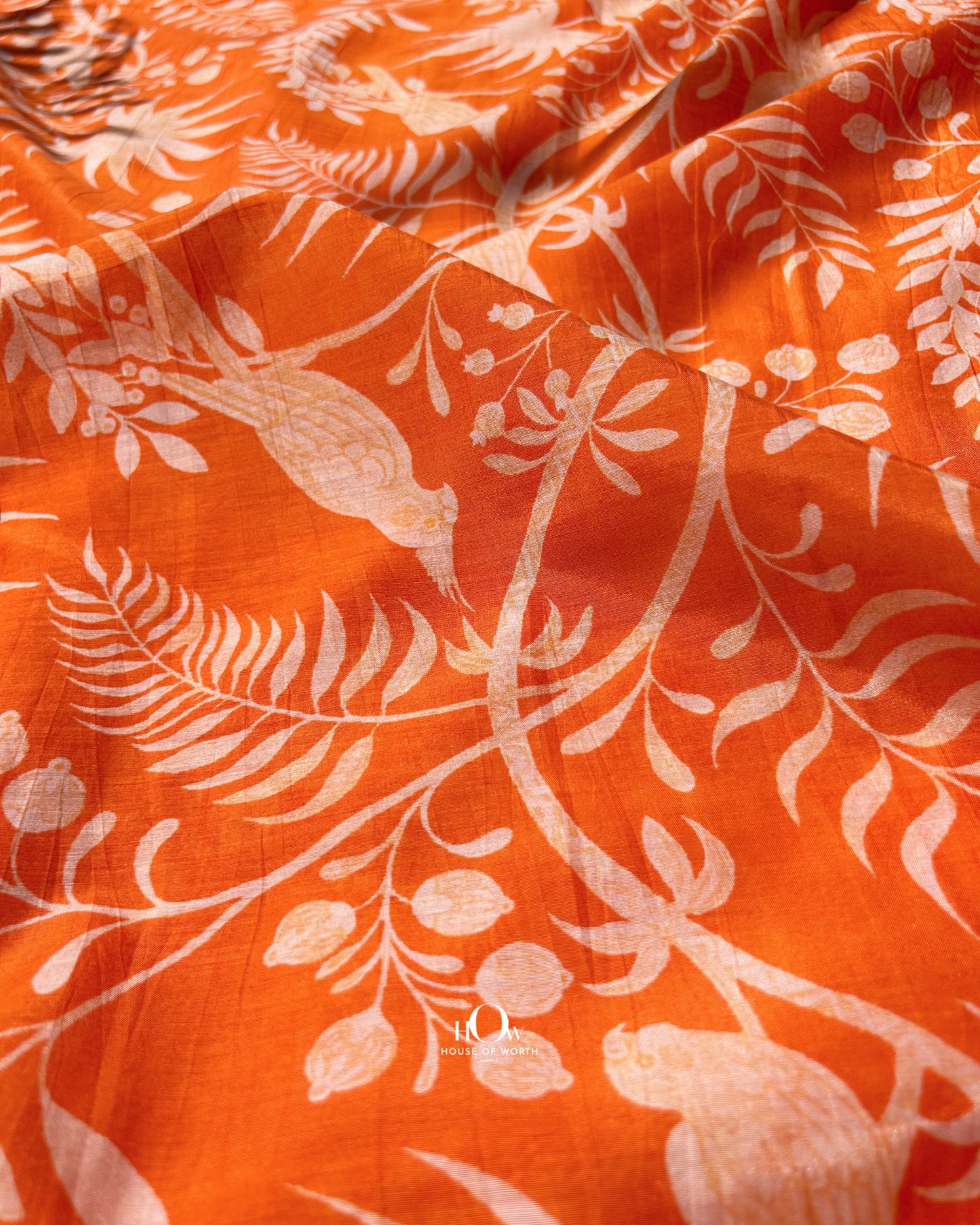 Bright orange Malai Chanderi fabric with nature pattern – soft and breathable material for summer suits.