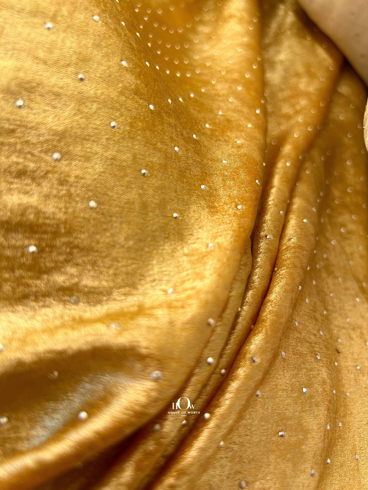 Heavy rhinestone fabric imported from China – used in festive wear, gowns, and designer sarees.