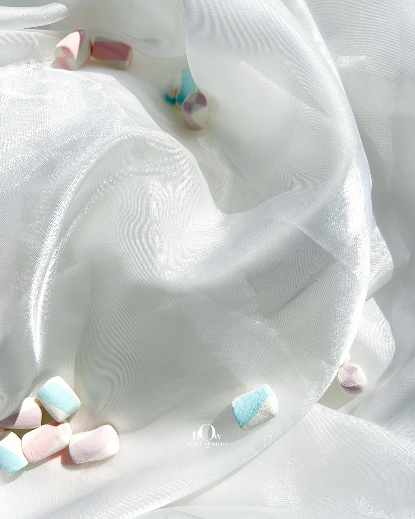 Translucent glass organza fabric with a high-gloss finish, perfect for luxury couture gowns.
