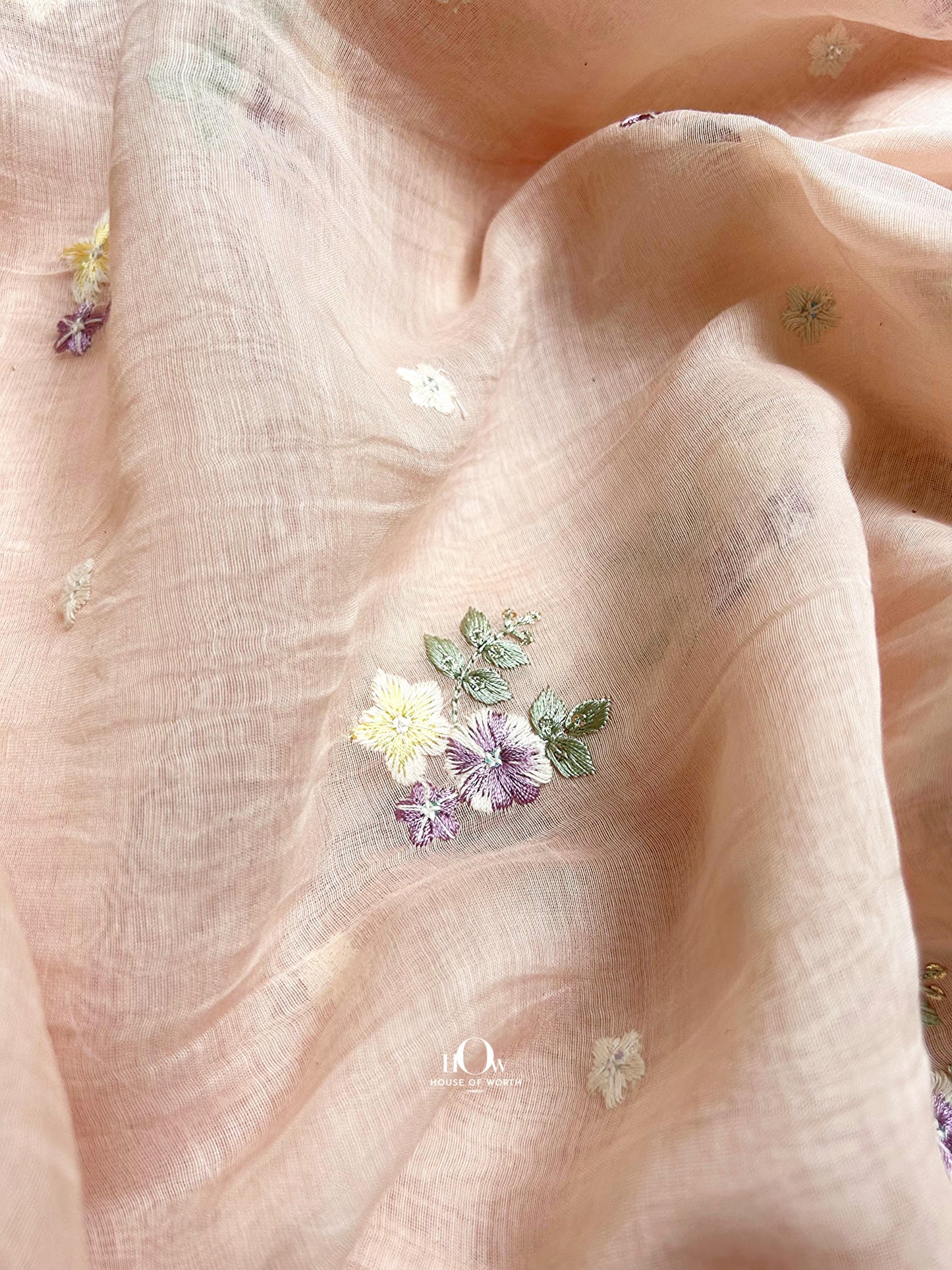 Soft Pure Mul Chanderi fabric in light peach – multicolor embroidery perfect for boutique tailoring and festive collections.