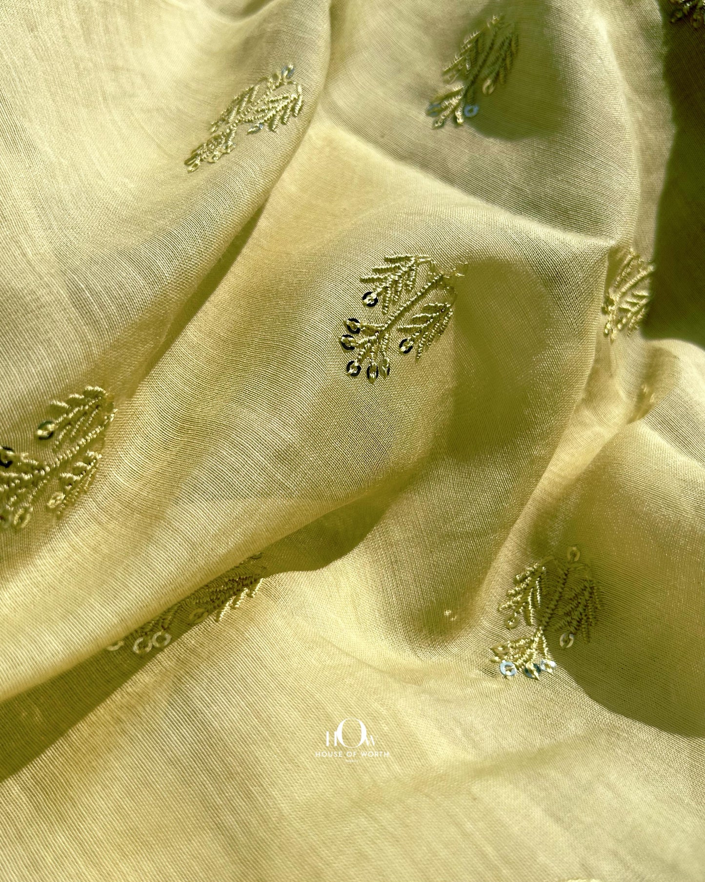 Buy yellow embroidered Mul Chanderi fabric in bulk – lightweight and breathable for ethnic tailoring and production.