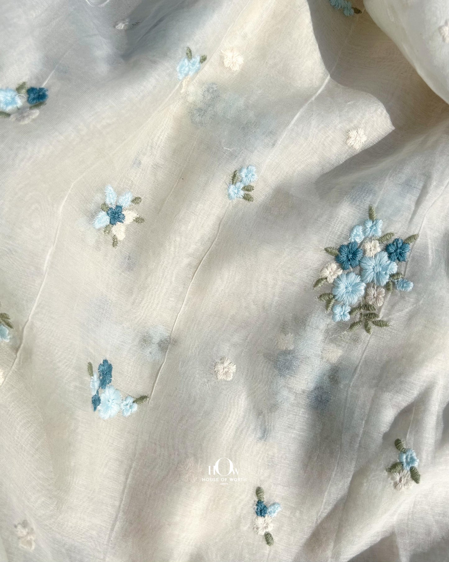Wholesale supplier of dyeable Pure Mul Chanderi fabric – off-white fabric with pastel embroidery for boutique use.