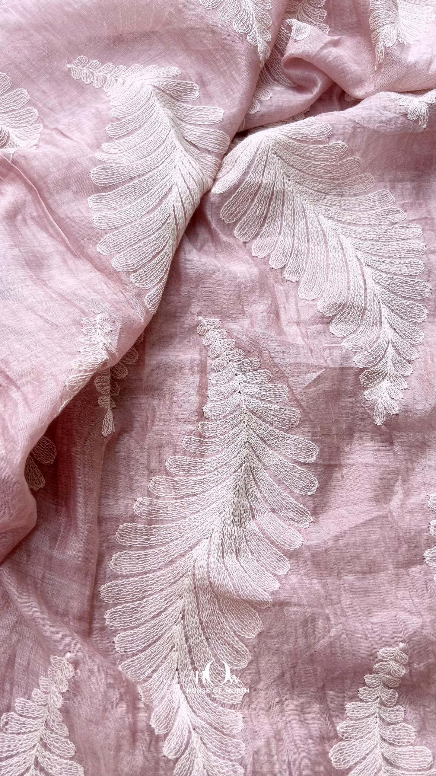 Pastel pink Chanderi fabric with woven leaf pattern – premium quality material for wholesale and retail fabric buyers.