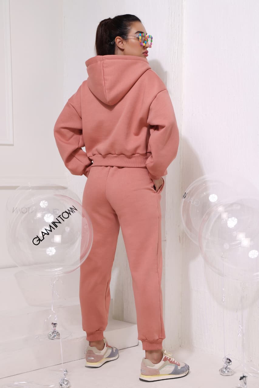 Pink women’s cozy hooded sweatshirt with drawstrings and relaxed joggers set