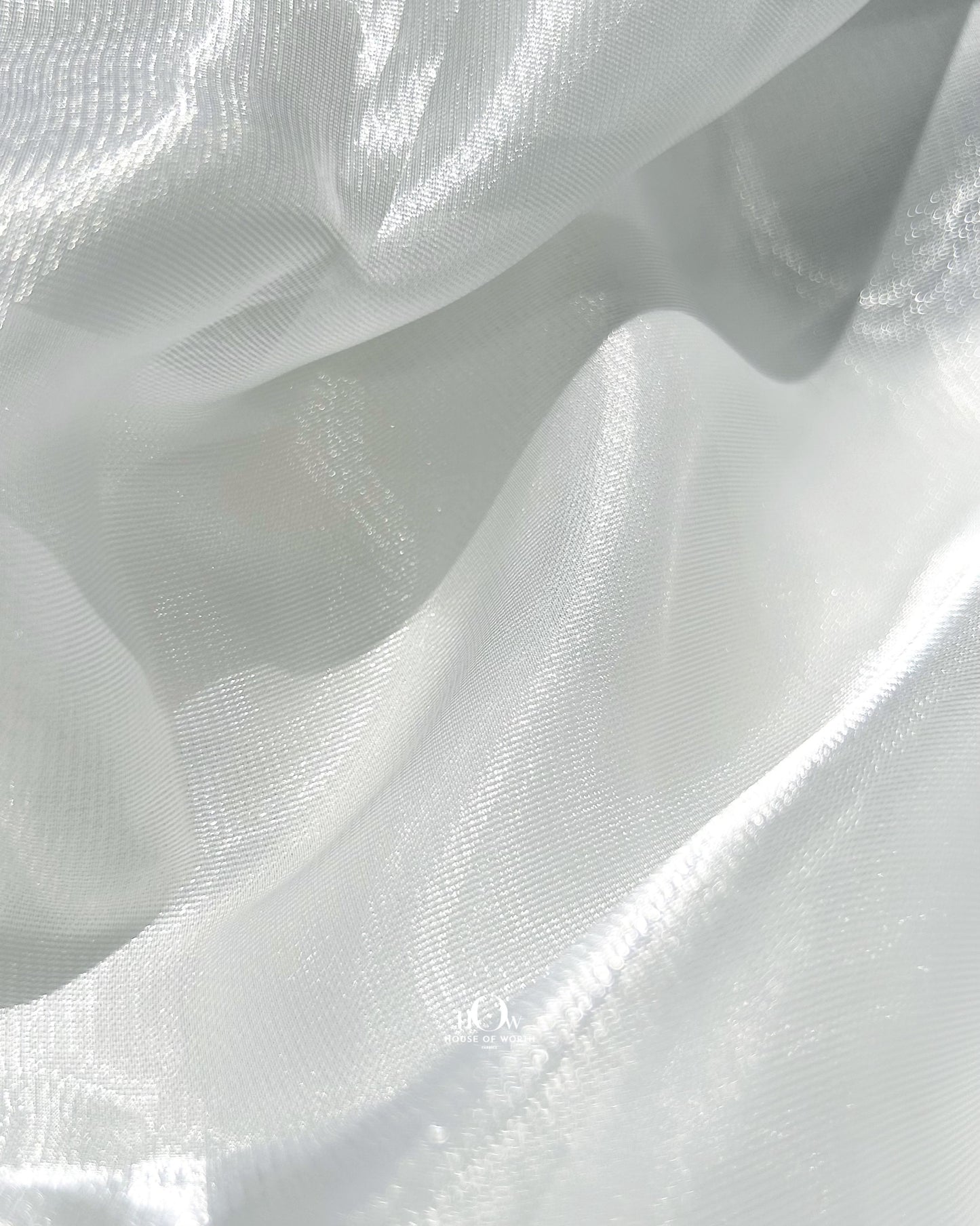 Luxurious glass organza dupatta for bridal lehengas, shining under showroom lights in Surat.