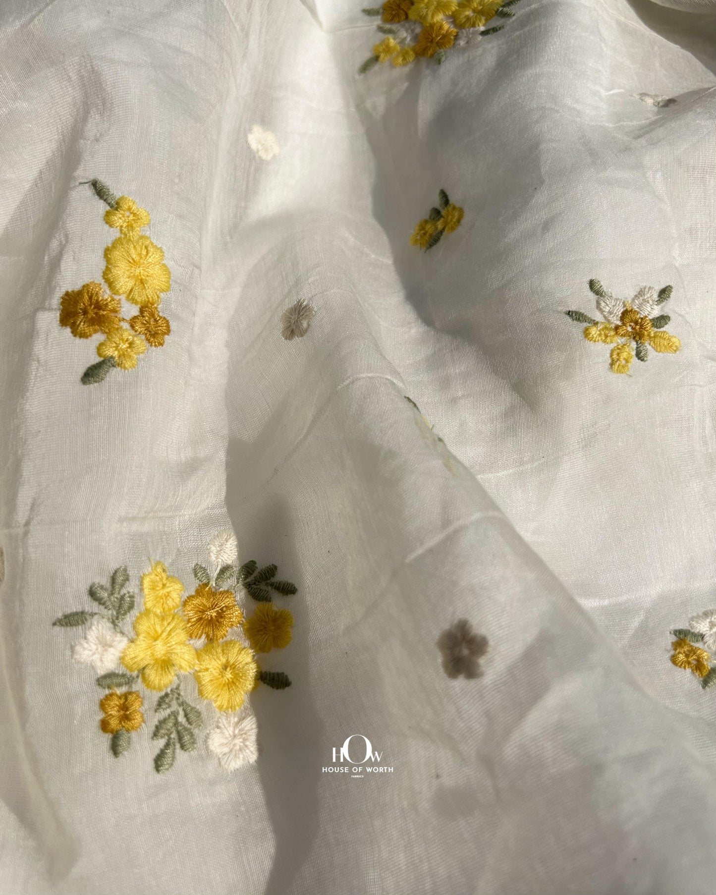 Buy pure Mul Chanderi fabric in bulk – soft off-white fabric with delicate yellow buttas for retail and wholesale orders.