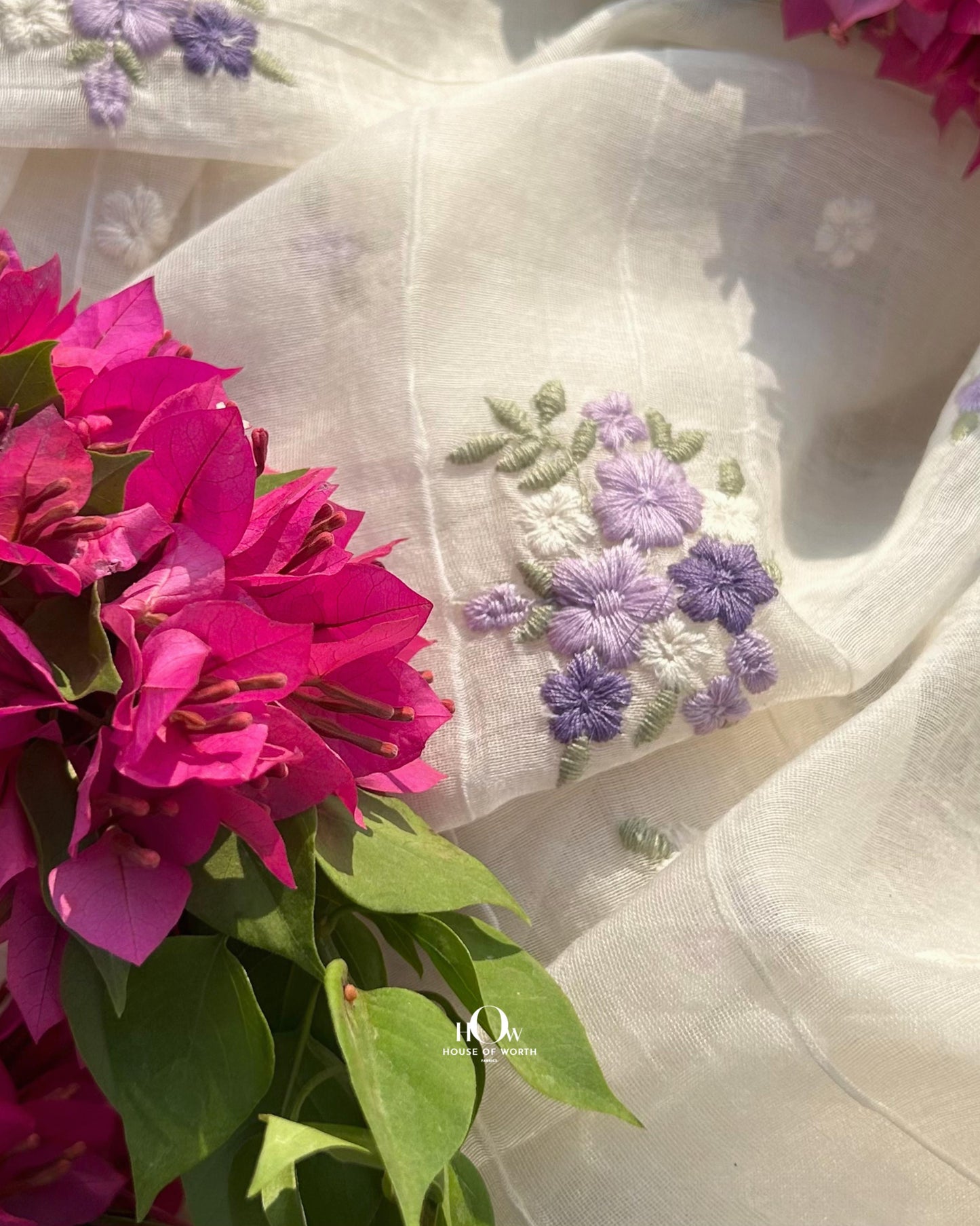 Buy pure Mul Chanderi dress material in bulk – subtle purple-blue floral motifs on soft dyeable fabric for ethnic tailoring.