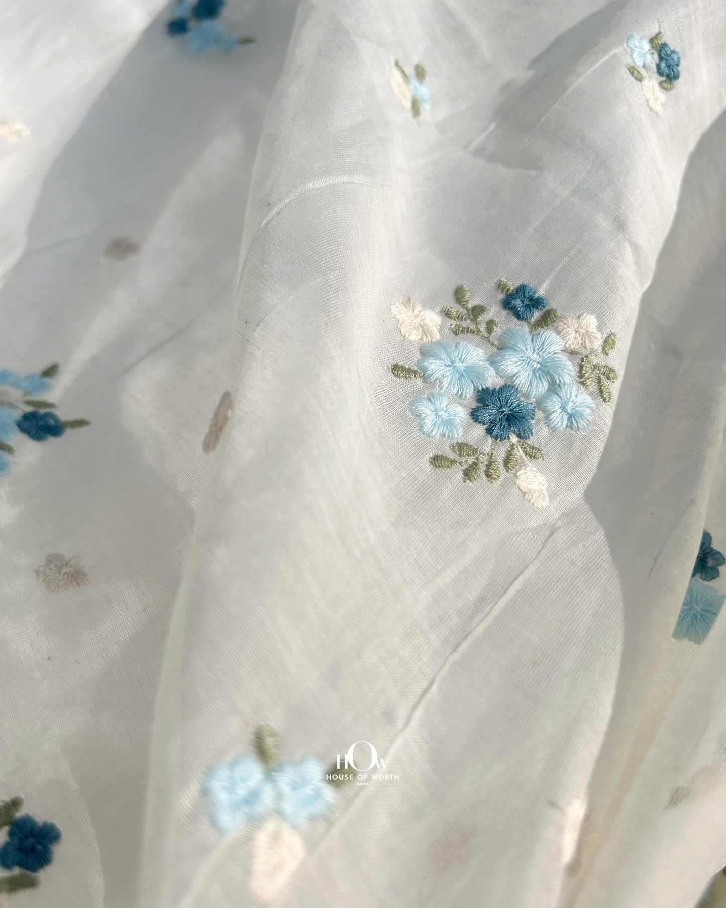 Floral butti embroidered Mul Chanderi fabric – off-white dyeable fabric perfect for festive and ethnic wear collections.