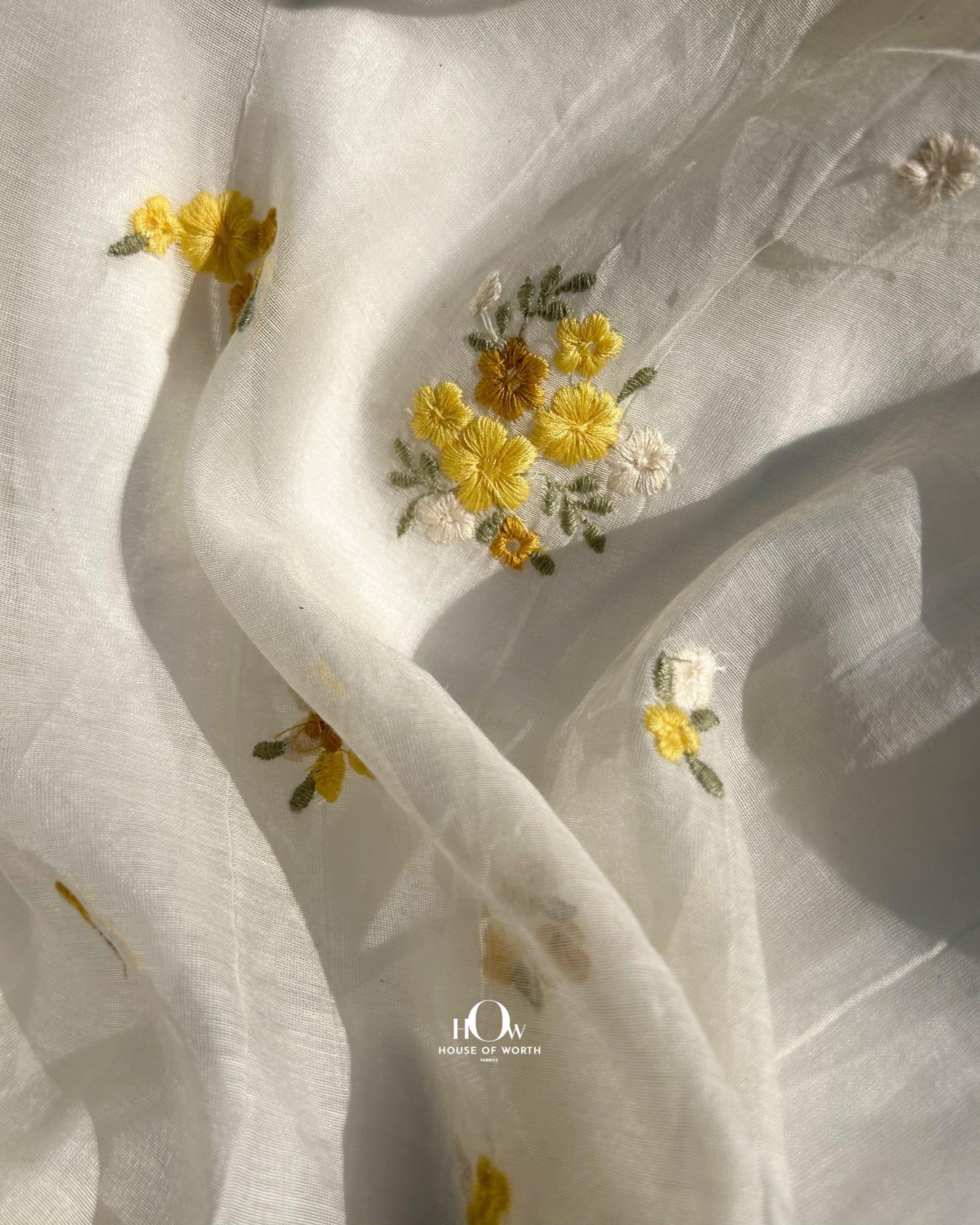 Yellow floral embroidered Mul Chanderi fabric – lightweight and breathable dyeable base available in Delhi, Surat, and Banaras.