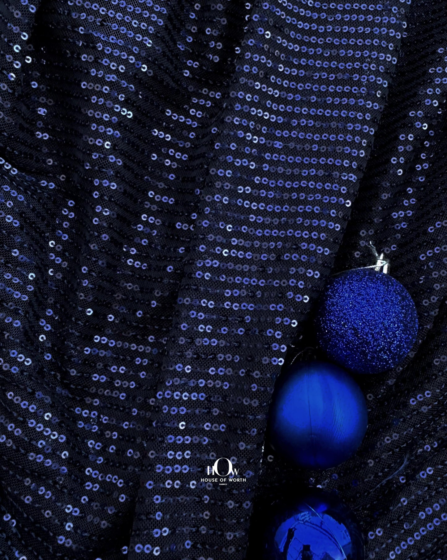Navy blue imported sequins fabric – ideal for partywear and available from fabric wholesalers in Mumbai.