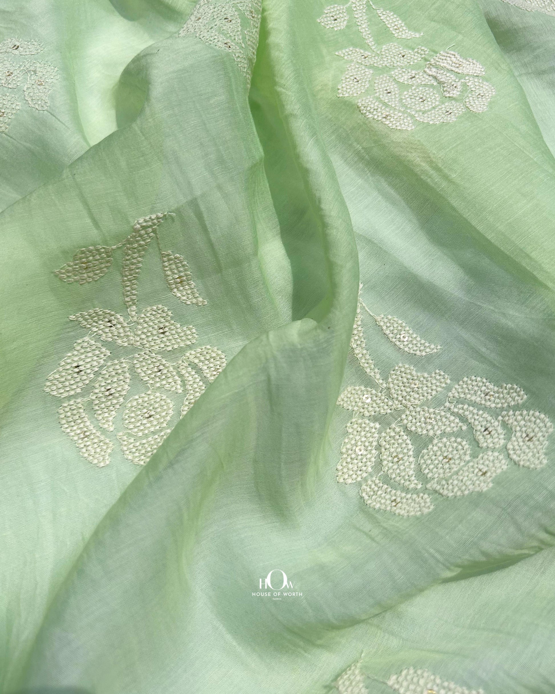 Embroidered green Mul Chanderi fabric for sarees and festive suits – soft, breathable and elegant.