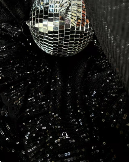 Glossy sequins fabric also known as Zara sequins, used for party gowns by Delhi fabric suppliers.