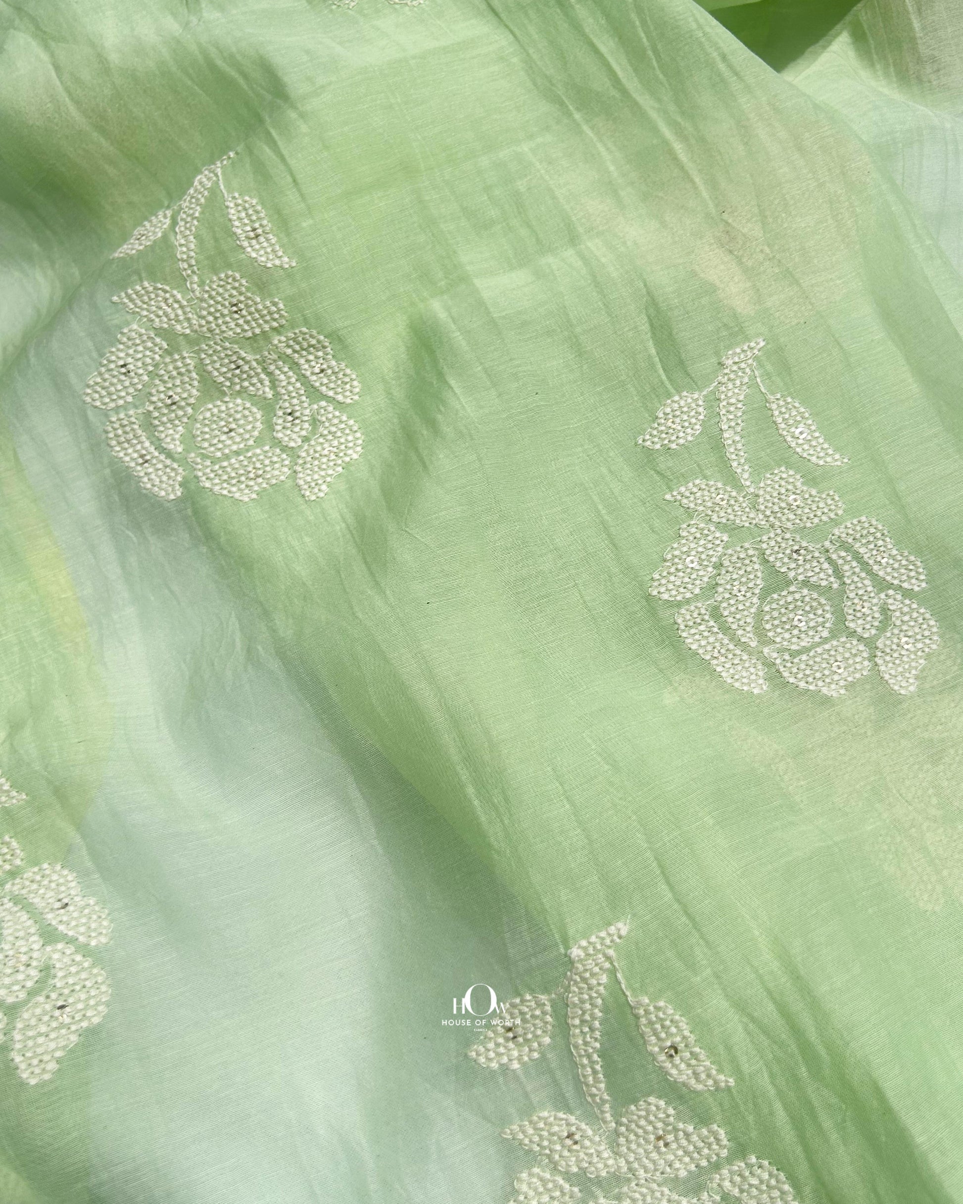 Draped green Mul Chanderi fabric with floral embroidery – ideal for designer kurtis and sarees.