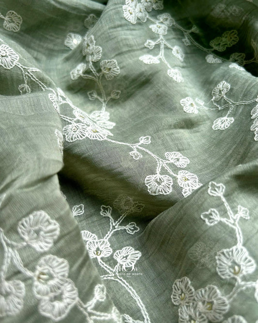 Pure Mul Chanderi fabric with white floral embroidery – pastel green material for kurtis, sarees, and dress sets.