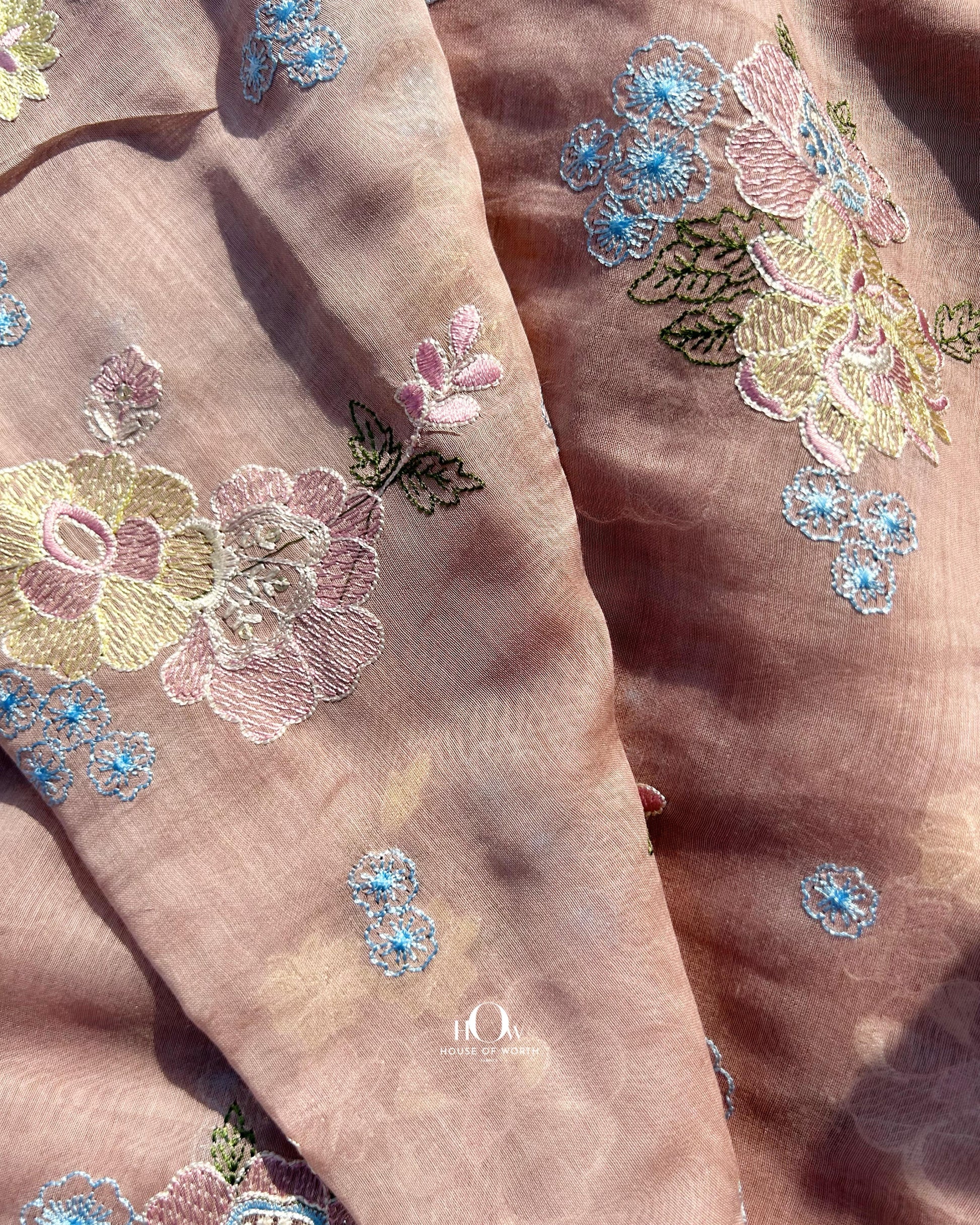 Buy pure Mul Chanderi fabric in bulk – soft handloom fabric with vibrant thread embroidery for ethnic tailoring.