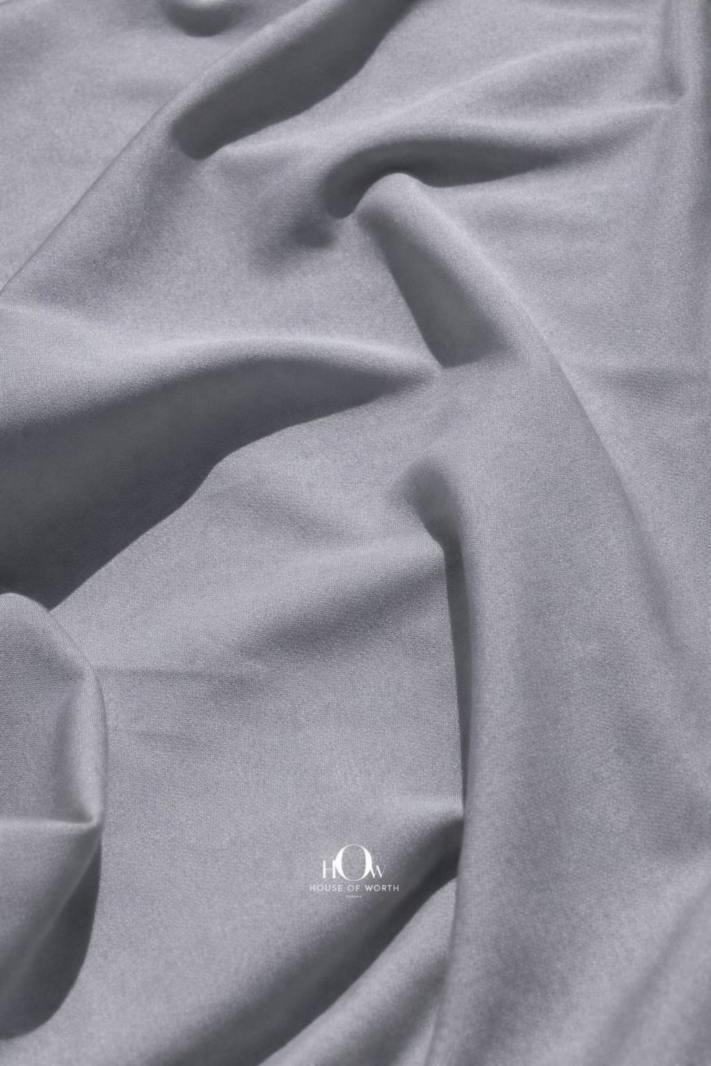 Grey banana crepe fabric close-up showing soft heavy crepe texture for blazers and trousers