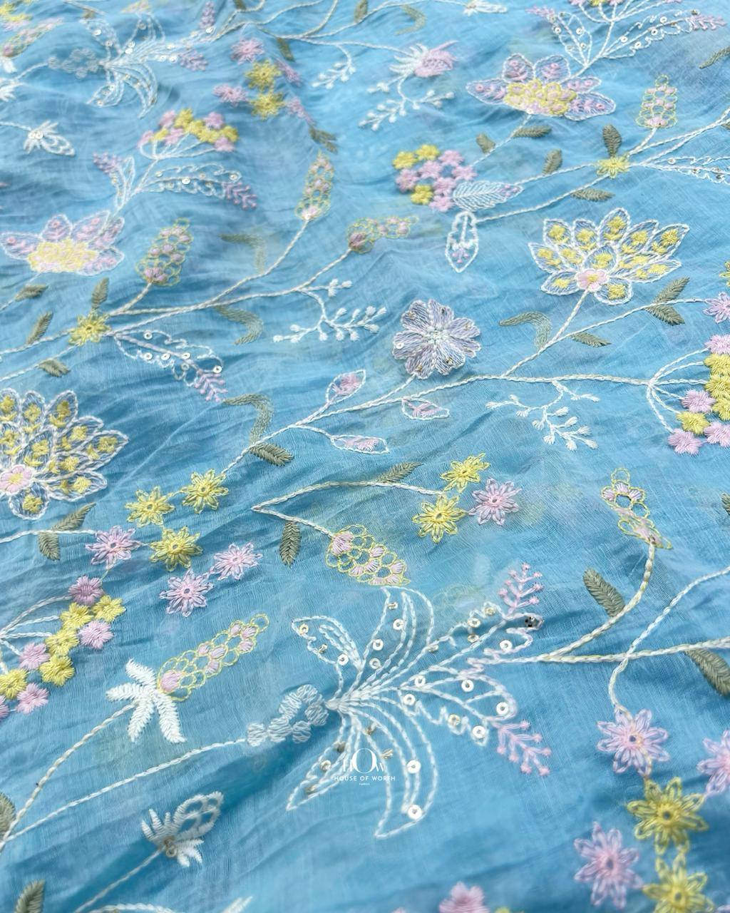 Traditional Chanderi handwoven fabric with delicate flower embroidery patterns