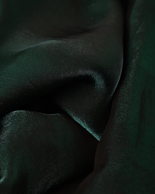 Rich emerald green imported glass chiffon fabric with a sheer, lightweight texture, draped elegantly for high-end gowns.