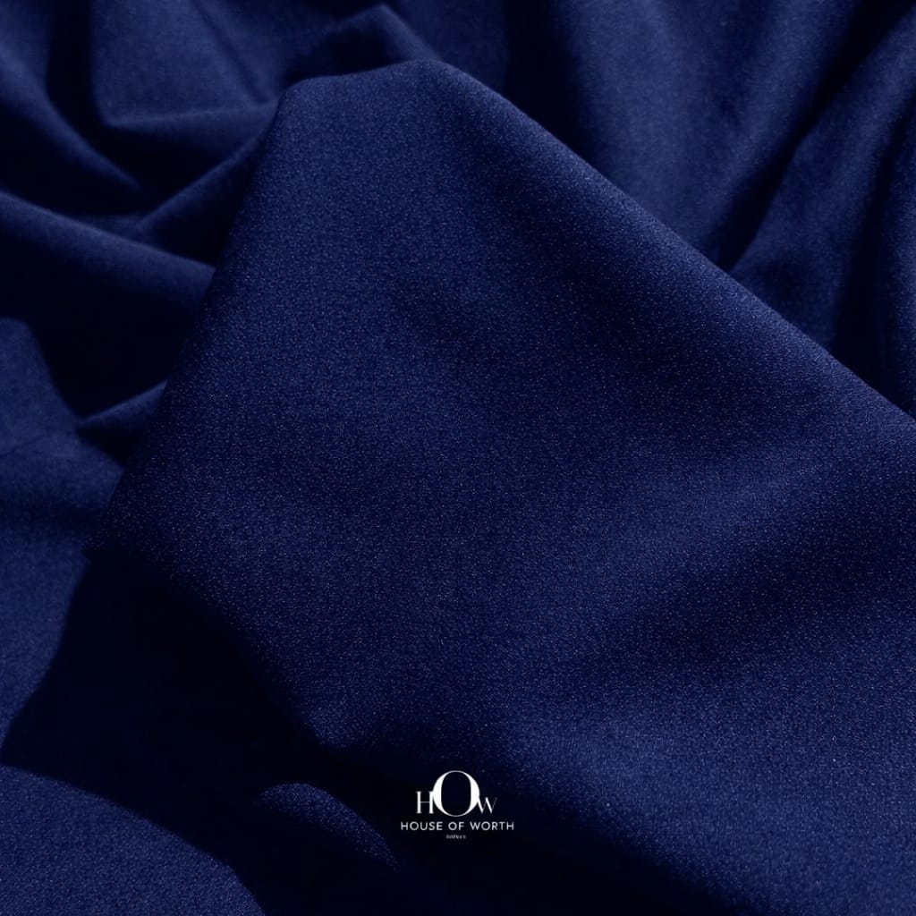 Close-up navy blue banana crepe texture, premium crepe material for blazers and trousers