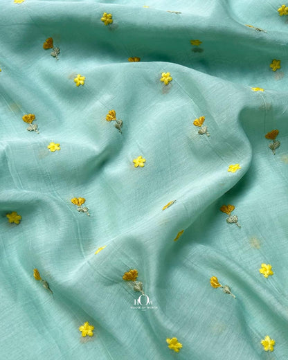 Soft pastel aqua pure mul chanderi fabric with delicate buti motifs.