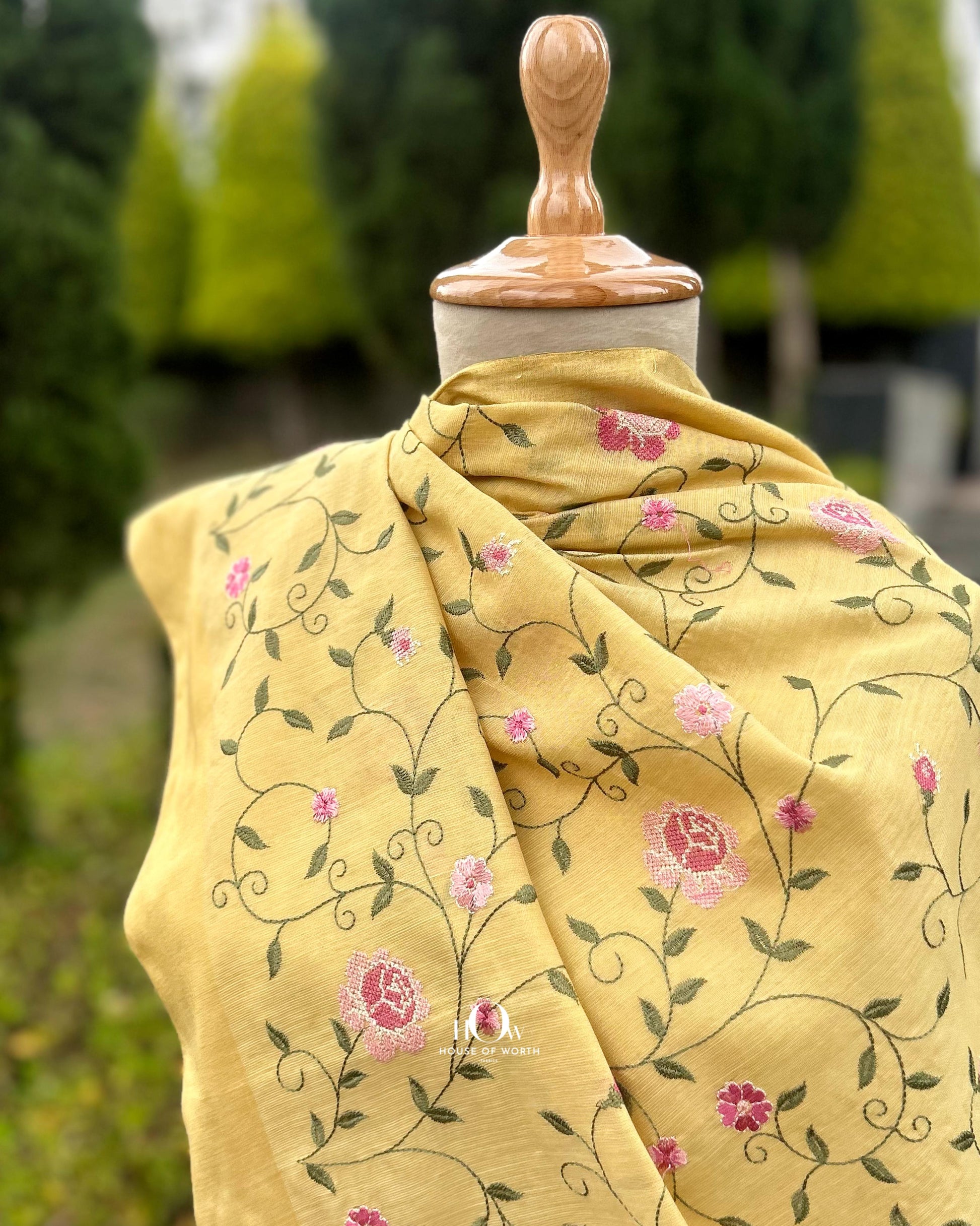 cotton tissue suit top with floral embroidery.