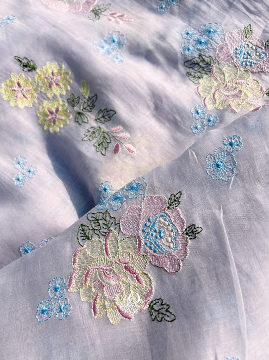 Pure Mul Chanderi fabric in lavender with pastel floral embroidery – perfect for suits, sarees, and occasion wear.