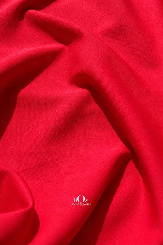 Red imported banana crepe fabric with smooth finish for party wear dresses and gowns