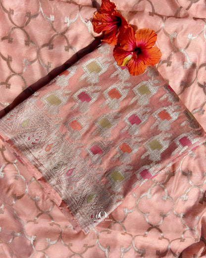 Unstitched peach festive suit set with pastel temple motifs and Banarasi fabric.
