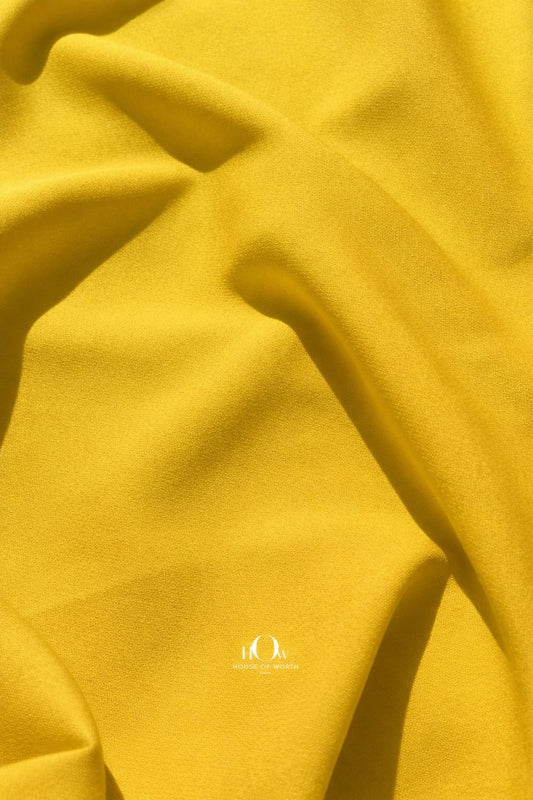 Yellow imported banana crepe fabric with smooth finish for summer dresses, skirts and co-ords