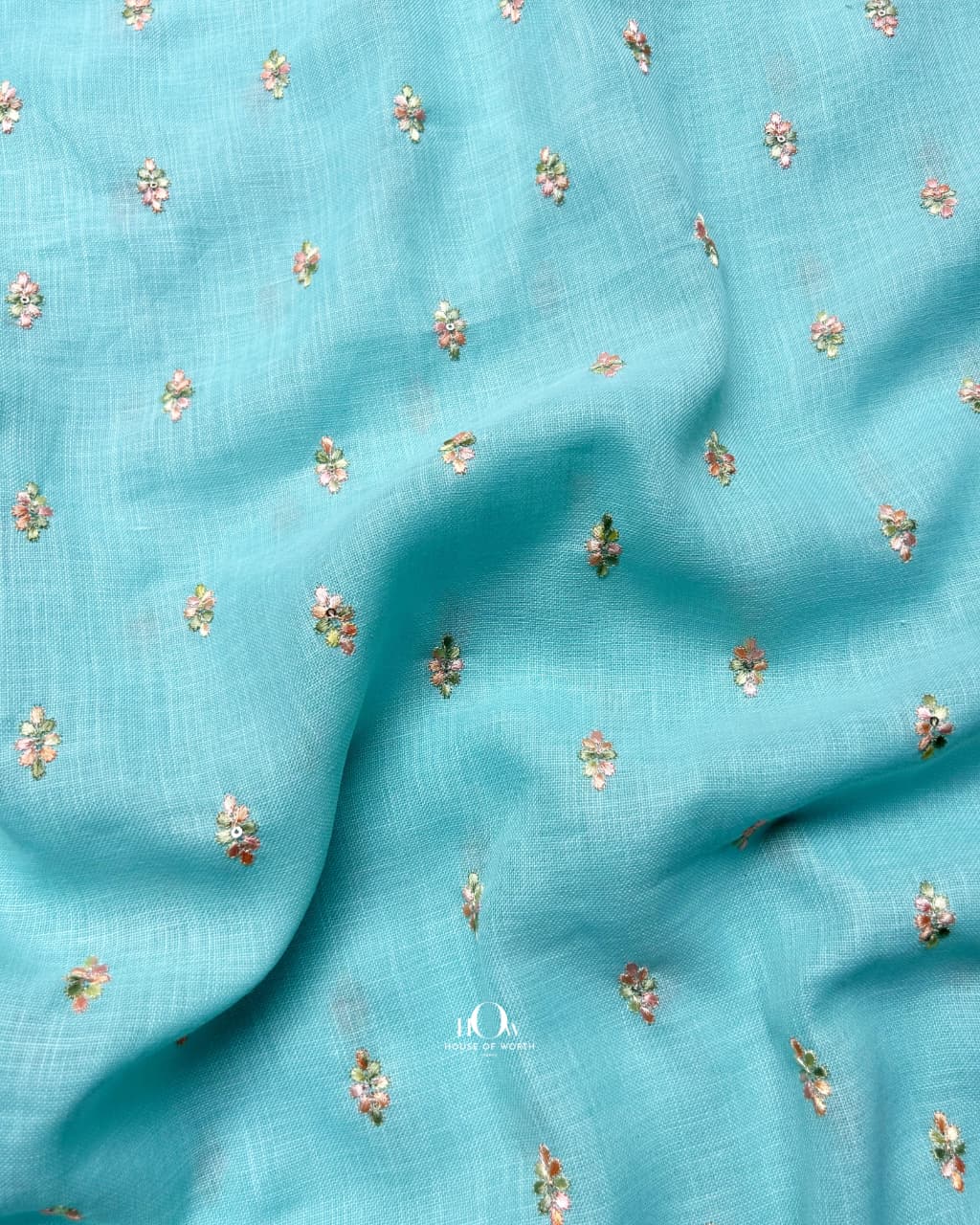 Premium aqua blue linen material with floral threadwork, perfect for kurta and dressmaking.