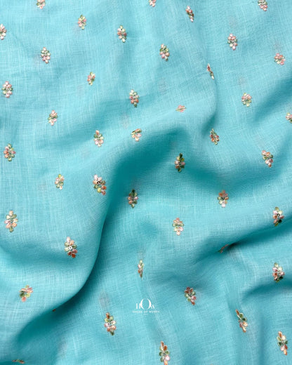 Premium aqua blue linen material with floral threadwork, perfect for kurta and dressmaking.
