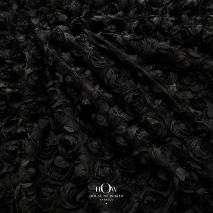 Black 3D floral applique fabric on net draped to show raised flowers
