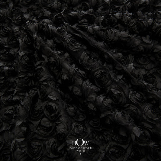 Black 3D floral applique fabric on net draped to show raised flowers