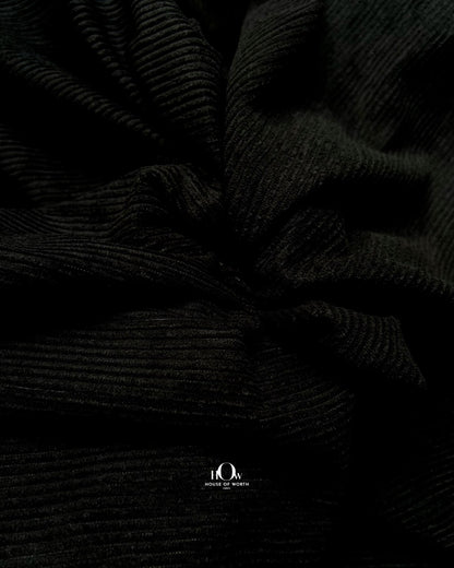 Black corduroy fabric with crisp linear ribbing and a clean solid black surface