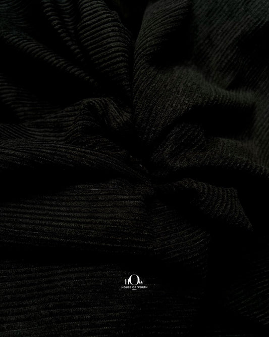 Black corduroy fabric with crisp linear ribbing and a clean solid black surface