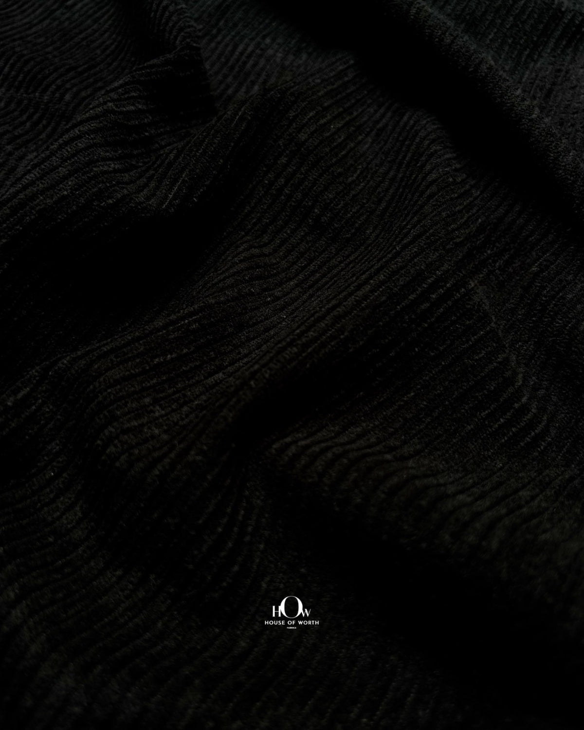 Black ribbed corduroy in folds for skirts, co-ords and contemporary western wear